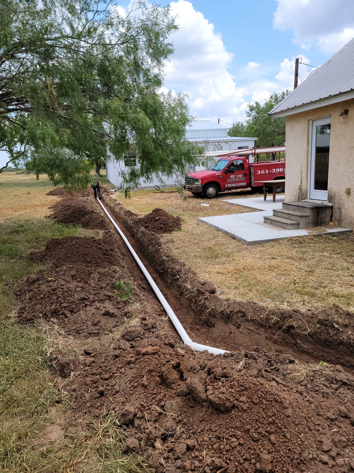 Sewage Pipe in trench beside home